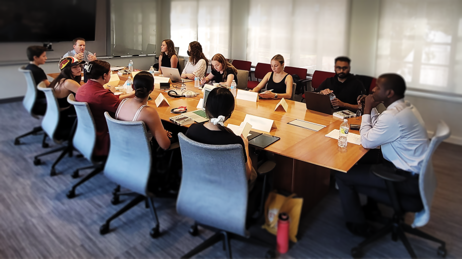 2022-2023 Undergraduate Research Fellows sitting around board room style table, conversing with special guest Jamal Greene